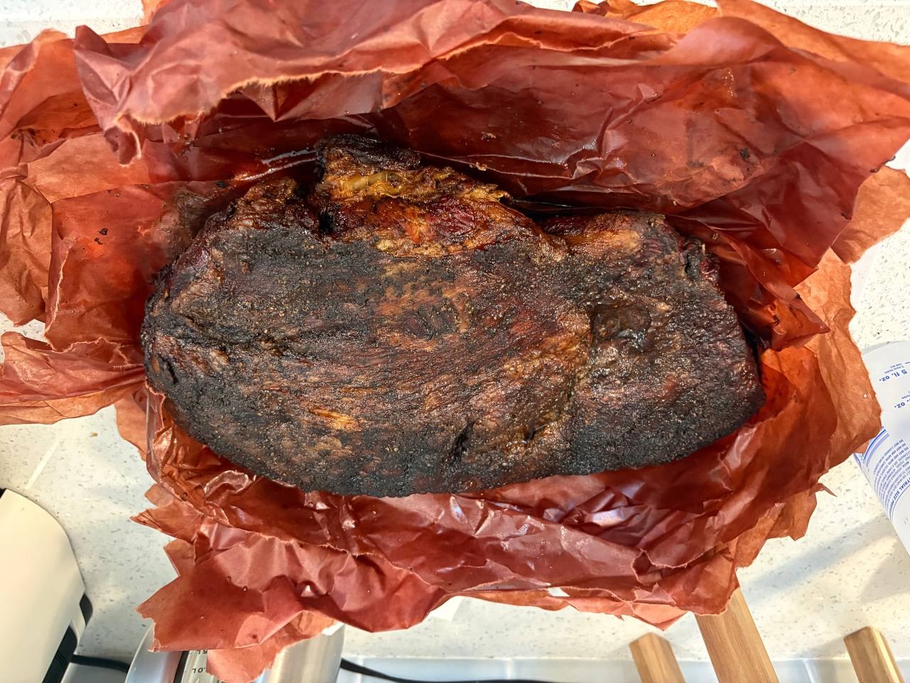 The finished whole brisket after resting, with a deep mahogany bark